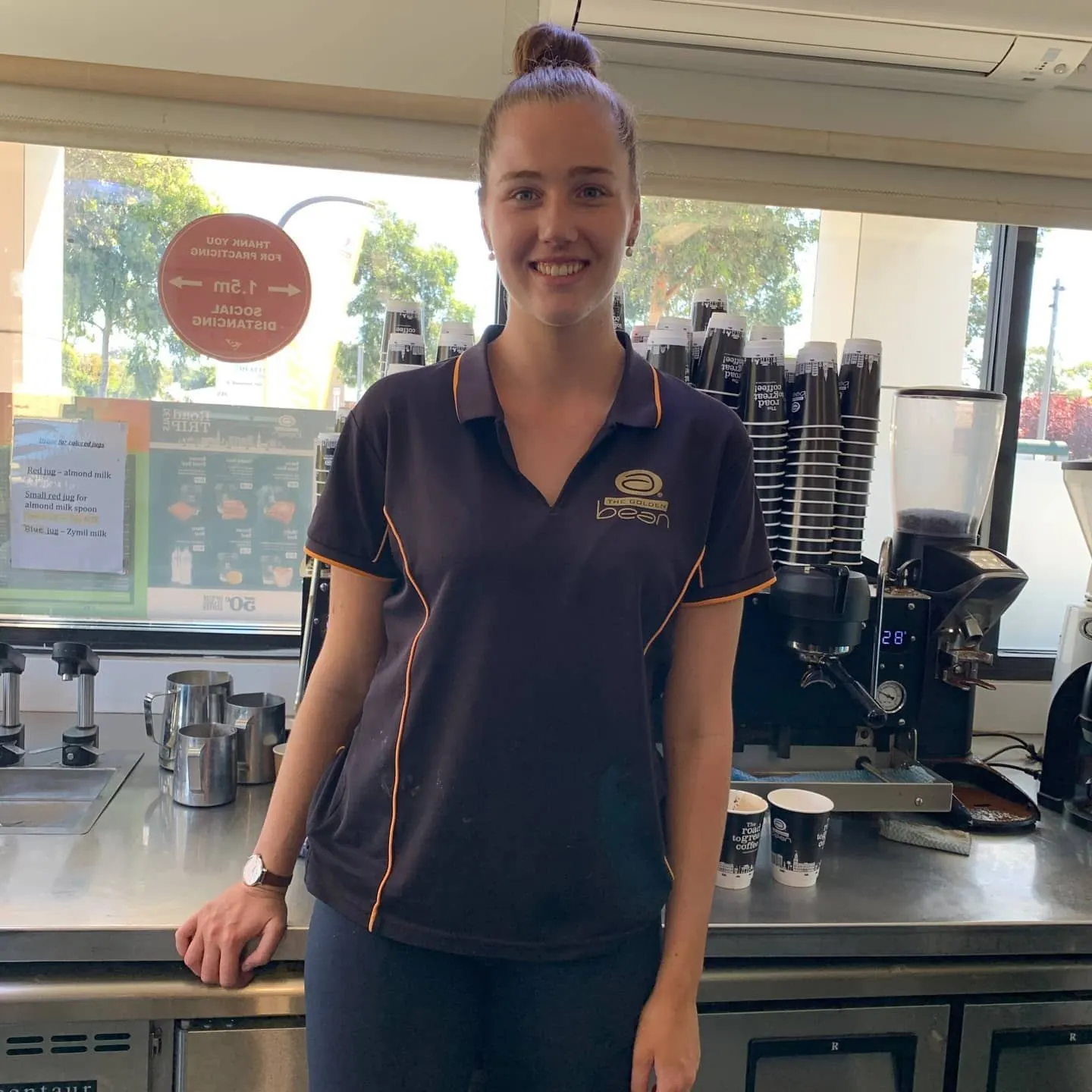 A Golden Bean barista behind the counter